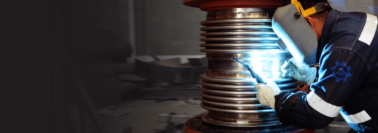 Worker welding an expansion joint